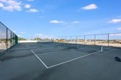 a tennis court with a net on top of it at Watercrest 901 2 BR 2 BA sleeps 8 Amazing balcony! in Panama City Beach