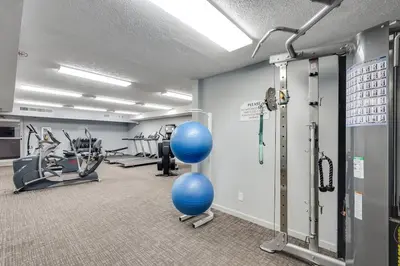 a gym with cardio equipment and blue balls in a room at Watercrest 901 2 BR 2 BA sleeps 8 Amazing balcony! in Panama City Beach
