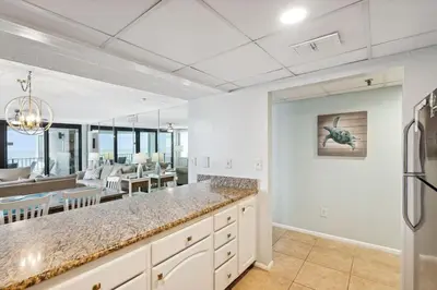 a kitchen with a counter and a dining room at Watercrest 502 - Perfect Family Getaway 2BR 2 BA in Panama City Beach