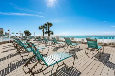 a row of chairs and tables on a beach at Watercrest 502 - Perfect Family Getaway 2BR 2 BA in Panama City Beach
