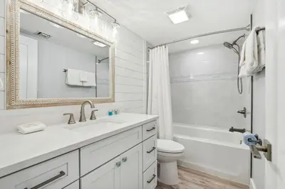 a white bathroom with a sink and a toilet at Watercrest 902 - Ocean Pearl Retreat - Renovated! in Panama City Beach
