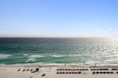 a view of a beach with chairs and the ocean at Watercrest 902 - Ocean Pearl Retreat - Renovated! in Panama City Beach
