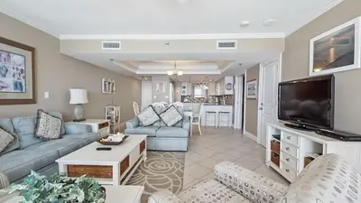 a living room with a couch and a tv at Watercrest 904 Beachfront 9th floor 3 BR 3 BA unit in Panama City Beach