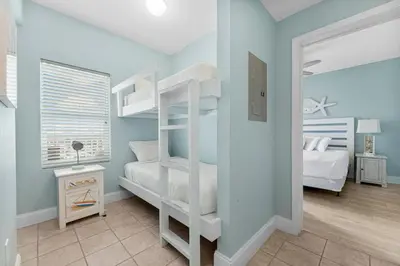 a bedroom with two bunk beds and a bed at Family-Friendly Laketown Wharf Retreat Near Pineapple Willy’s & Beach in Panama City Beach