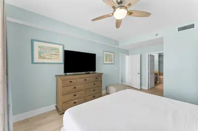 a bedroom with a bed and a flat screen tv at Family-Friendly Laketown Wharf Retreat Near Pineapple Willy’s & Beach in Panama City Beach