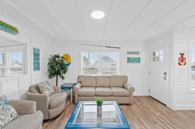 a living room with two couches and a table at Spacious Dog-Friendly Duplex w/ Bonus Game Room & Private Backyard Near Beach in Panama City Beach