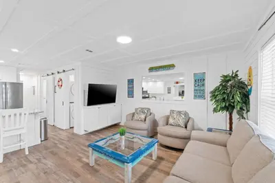 a living room with a couch and a table at Spacious Dog-Friendly Duplex w/ Bonus Game Room & Private Backyard Near Beach in Panama City Beach