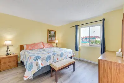 a bedroom with a bed and a window at Steps to Shore PCB Condo with Pool Access and Balcony in Panama City Beach