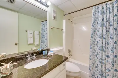 a bathroom with a sink and a toilet and a shower at Steps to Shore PCB Condo with Pool Access and Balcony in Panama City Beach