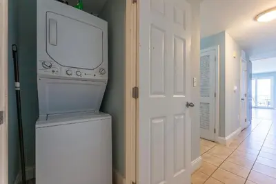 a laundry room with a white washer and dryer at Laketown Wharf Condo beach view in Panama City Beach