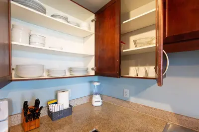 a kitchen counter with cabinets full of dishes at Laketown Wharf Condo beach view in Panama City Beach