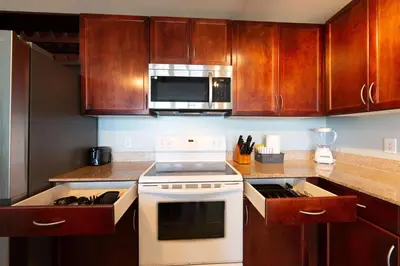 a kitchen with a white stove and a microwave at Laketown Wharf Condo beach view in Panama City Beach