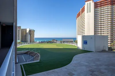 a view of a golf course from the balcony of a building at Laketown Wharf Condo beach view in Panama City Beach