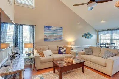 a living room with a couch and a table at Walk to Beaches Resort Getaway Near Pier Park! in Panama City Beach