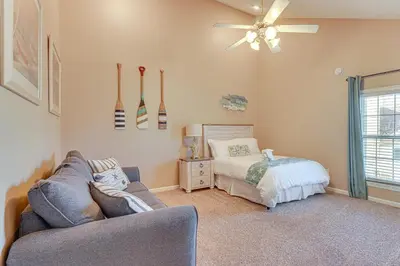 a living room with a couch and a bed at Walk to Beaches Resort Getaway Near Pier Park! in Panama City Beach
