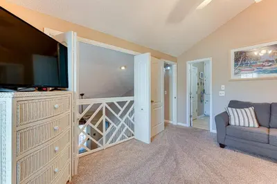 a living room with a tv and a couch at Walk to Beaches Resort Getaway Near Pier Park! in Panama City Beach