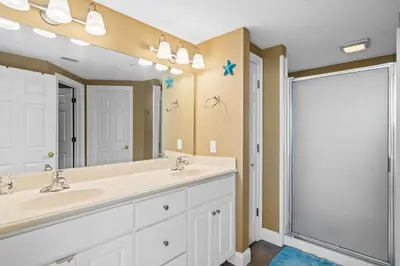 a bathroom with two sinks and a large mirror at Treasure Island #2101 in Panama City Beach