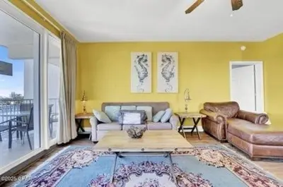 a living room with a couch and a table at Laketown Wharf 338 condo in Panama City Beach
