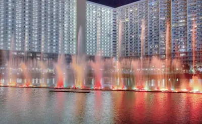 a water fountain in front of a large building at Laketown Wharf 338 condo in Panama City Beach