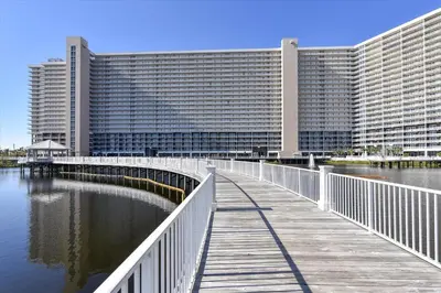 a bridge over a body of water in front of a large building at Laketown Wharf 338 condo in Panama City Beach
