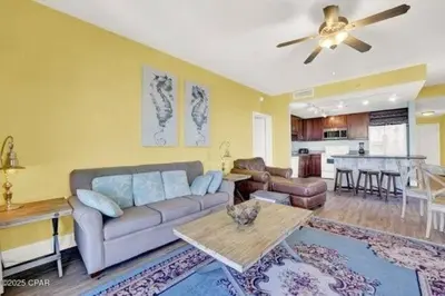 a living room with a couch and a table at Laketown Wharf 338 condo in Panama City Beach