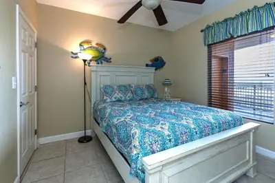 a bedroom with a bed and a ceiling fan at Splash Ocean-front Luxury Two-bedroom Beach Condo in Panama City Beach