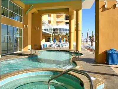 a swimming pool in front of a building at Splash Ocean-front Luxury Two-bedroom Beach Condo in Panama City Beach
