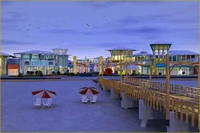 a pier with chairs and umbrellas on the beach at Splash Ocean-front Luxury Two-bedroom Beach Condo in Panama City Beach