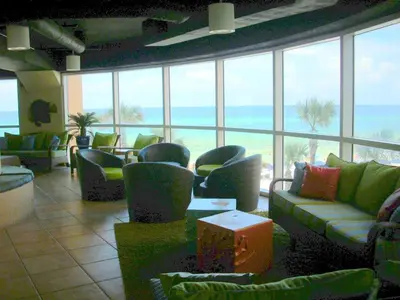 a lobby with couches and chairs and a view of the ocean at Splash Ocean-front Luxury Two-bedroom Beach Condo in Panama City Beach