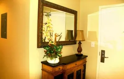 a room with a mirror and a table with a lamp at Splash Ocean-front Luxury Two-bedroom Beach Condo in Panama City Beach
