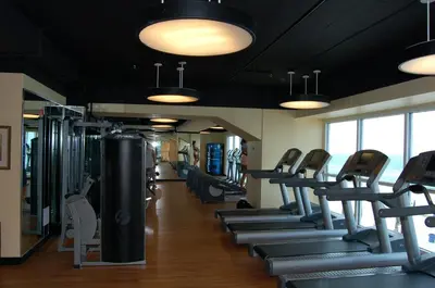 a gym with a row of treadmills and chairs at Splash Ocean-front Luxury Two-bedroom Beach Condo in Panama City Beach