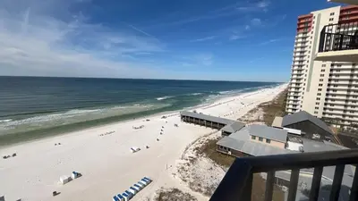 a view of a beach from a balcony of a building at Sunbird Resort 10th Floor Amazing Sunsets - by Sunbird Rentals in Panama City Beach