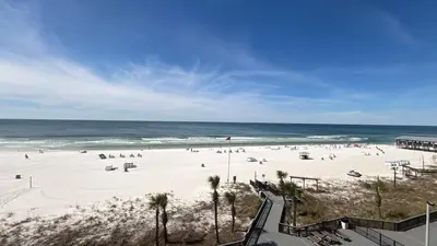 a beach with a lot of people and the ocean at Sunbird Resort 10th Floor Amazing Sunsets - by Sunbird Rentals in Panama City Beach