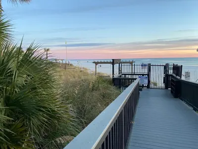 a boardwalk leading to a beach with the ocean at Sunbird Resort - First Floor - Free Beach Chairs by Sunbird Rentals in Panama City Beach