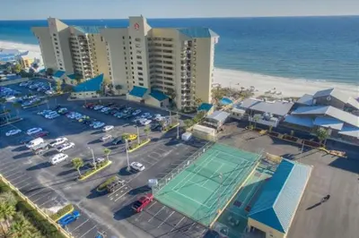 an aerial view of a parking lot with a tennis court at Sunbird Resort - First Floor - Free Beach Chairs by Sunbird Rentals in Panama City Beach