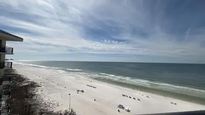 a view of a beach with people and the ocean at Sunbird Resort 11th Floor Free Beach Chairs - by Sunbird Rentals in Panama City Beach