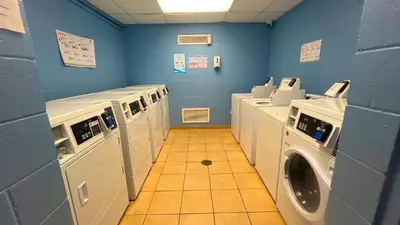 a laundry room with washers and dryers in it at Sunbird Resort 8th Floor Sunsets - by Sunbird Rentals in Panama City Beach