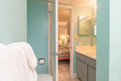a bathroom with a sink and a toilet and a tub at Sunbird Resort 8th Floor Sunsets - by Sunbird Rentals in Panama City Beach
