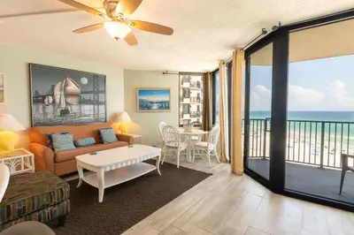 a living room with a couch and a table at Sunbird Resort 8th Floor Stunning Beach View - by Sunbird Rentals in Panama City Beach