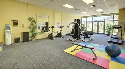 a gym with a lot of exercise equipment in a room at Sunbird Resort 8th Floor Stunning Beach View - by Sunbird Rentals in Panama City Beach