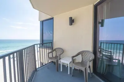 two chairs and a table on a balcony with the ocean at Sunbird Resort 8th Floor Stunning Beach View - by Sunbird Rentals in Panama City Beach