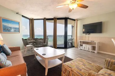 a living room with a couch a table and a tv at Sunbird Resort 8th Floor Stunning Beach View - by Sunbird Rentals in Panama City Beach