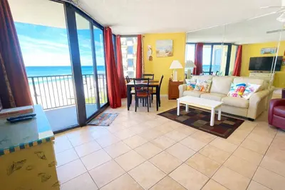 a living room with a view of the ocean at Sunbird Resort 5th Floor Amazing View! - by Sunbird Rentals in Panama City Beach