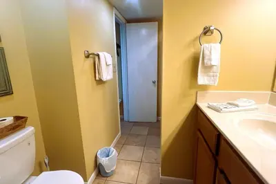 a bathroom with a white toilet and a sink at Sunbird Resort 5th Floor Amazing View! - by Sunbird Rentals in Panama City Beach