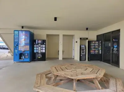 a room with a wooden table and two gas pumps at Sunbird Resort 5th Floor Amazing View! - by Sunbird Rentals in Panama City Beach