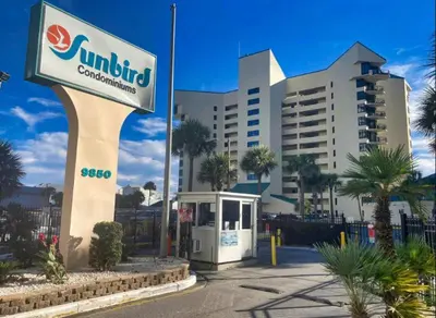 a building with a sign in front of it at Sunbird Resort 5th Floor Amazing View! - by Sunbird Rentals in Panama City Beach