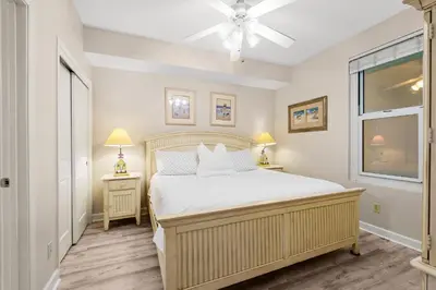 a bedroom with a large bed and a window at Gulf-Front Corner Unit! Stunning Coastline Views! by Dolce Vita Getaways PCB in Panama City Beach