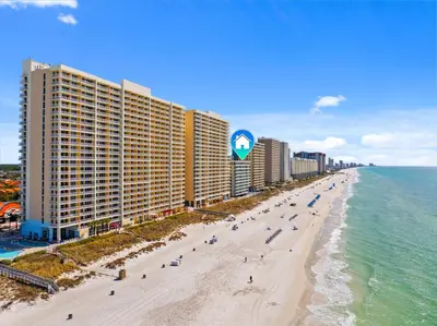 an aerial view of a beach with buildings and the ocean at Gulf-Front Corner Unit! Stunning Coastline Views! by Dolce Vita Getaways PCB in Panama City Beach