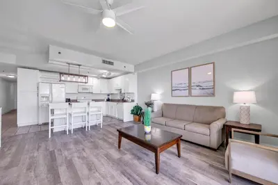 a living room with a couch and a table at Laketown Wharf 1116 in Panama City Beach