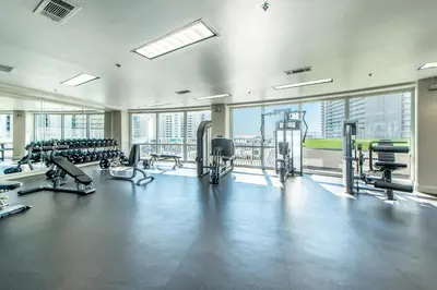 a gym with treadmills and machines in a building at Laketown Wharf 1116 in Panama City Beach